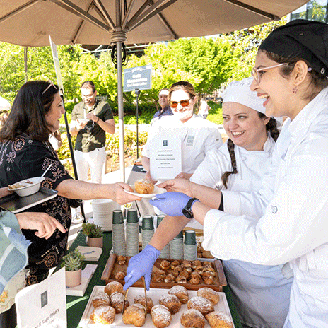Chefs serve guests at the 2024 Bits & Bites event.