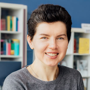 a portrait photo of a student college coach smiling