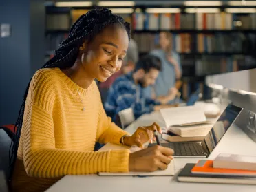 A photo of an African-American woman working in a library.