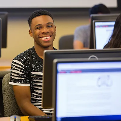 Student in a computer lab working at a desktop computer