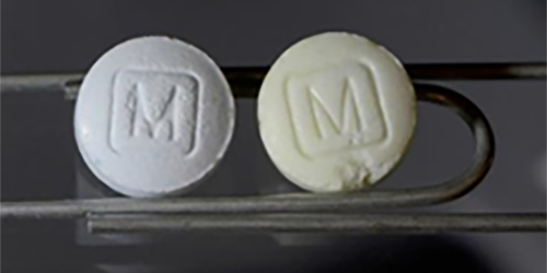 Image of two pills, a white one is synthetic fentanyl and the yellow one is impure fentanyl