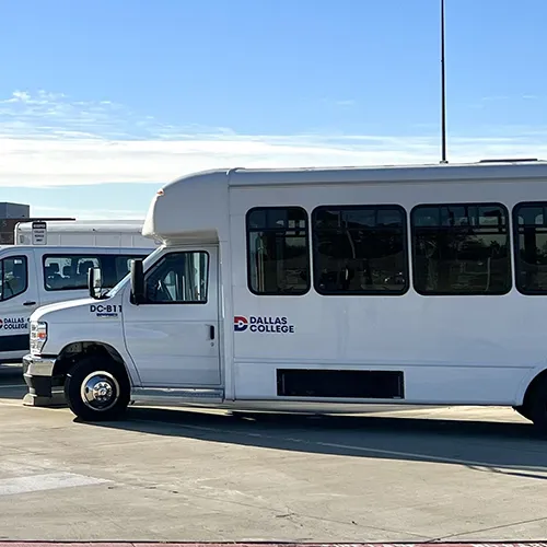 white shuttle van with dallas college logo on the side