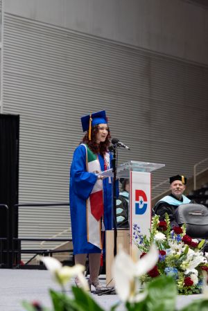 Graduate speaking at graduation.