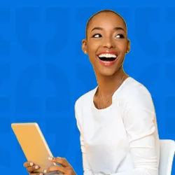 A smiling person holding a tablet against a vibrant blue background with Dallas College geometric patterns